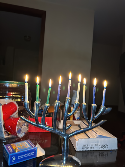 Chanukiah shaped like the Tree of Life with nine lit candles