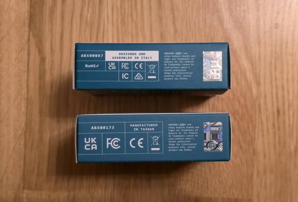 Similar boxes of Arduino Uno R4 WiFi Board with "Designed and assembled in Italy" written and Arduino Uno Q with "Manufactured in Taiwan" written on it