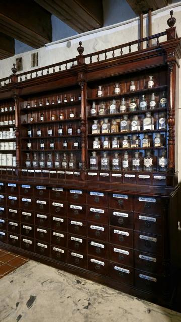 Oficina (prescription room) in Museum of the History of Lithuanian Medicine and Pharmacy - huge wooden shelves with labelled drawers and glass containers to store medications