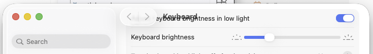 part of macOS Tahoe System Settings for Keyboard, where the 'Keyboard' title at the top is completely obscured by a text label that has scrolled behind it.