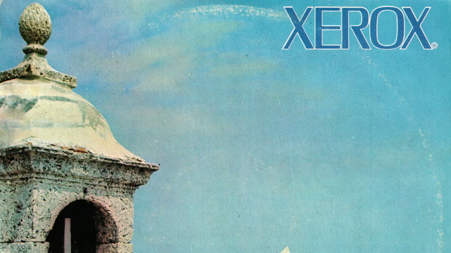 The cover of the Xerox Volumen V album slowly scrolls by as the title of the playing song ("El Canelazo" by Orquesta América) shows onscreen.

The cover art features a stone structure on the left overlooking a blue sea and a blue sky. There is a small sailboat on the water in the distance. The Xerox logo is in the upper right, and "VOLUMEN V" is written vertically in the bottom right corner.