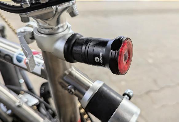 a standard tail-light with brake sensor, mounted onto a Vello folding bike frame with a custom 3d-printed adapter