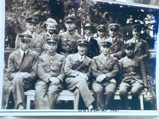 12 Lithuanian people in uniform posing outside for a photo taken in 1937 - Darbėnai, Lithuania