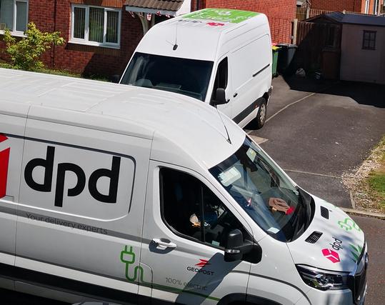Photo showing two DPD delivery vans parked in the street delivering to two different houses.