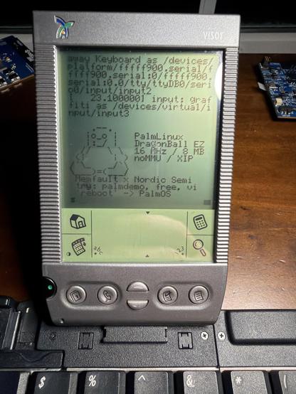 A picture of a Handspring Visor PDA, booted to a Linux prompt, docked to a keyboard.