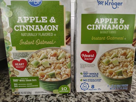 Two nearly-identical boxes of Kroger Instant Oatmeal sit side by side on a counter. The one on the left, which I bought maybe a month ago, has 10 packets of oatmeal. On the right, the just-purchased box has 8 packets.