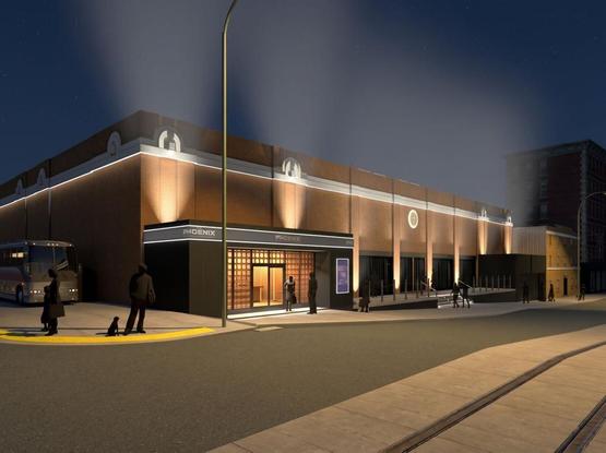 Computer-rendered image of a large, relatively low brick-faced building at night. In corner closest to the viewer there is an entrance with "Phoenix" signs. A tour bus is parked off the side of the building. In the foreground is a street with a streetcar track. There are ten people shown in the image, and no cars.