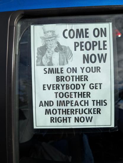 poster seen in car window "Come on people No ..." with lyrics change to end with "...and impeach this Mother-fCKer right now.
