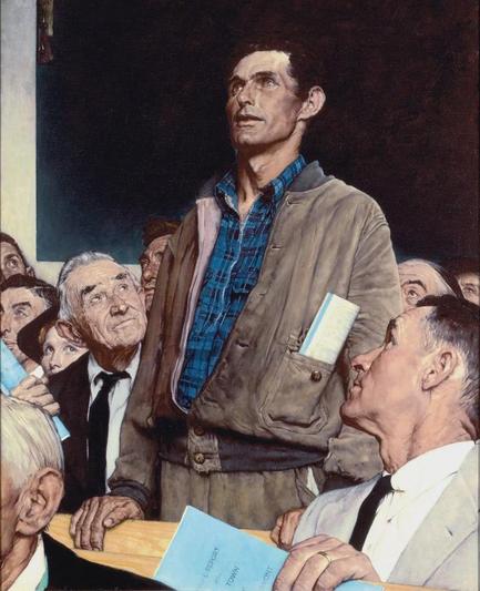 Man standing up at town hall meeting