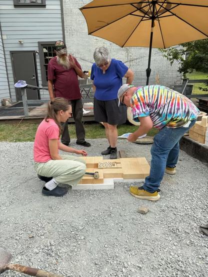 A group of kiln builders laying bricks