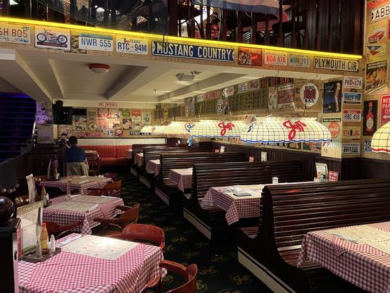 Inside of the restaurant, which looks like an American diner with a lot of US-themed decorations like license plates and some signs