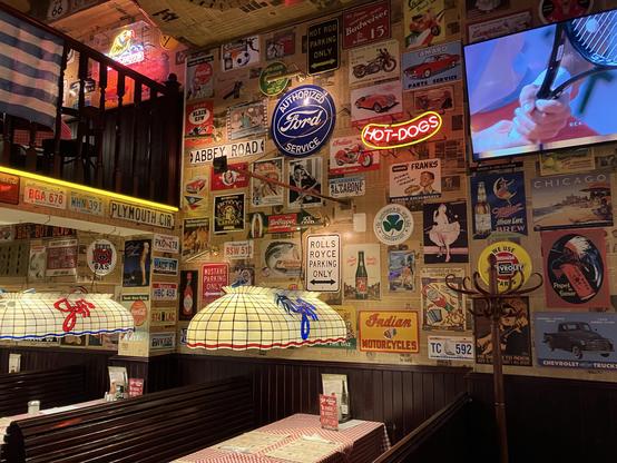 Wall in the restaurant, covered with US-themed decorations like license plates and some signs