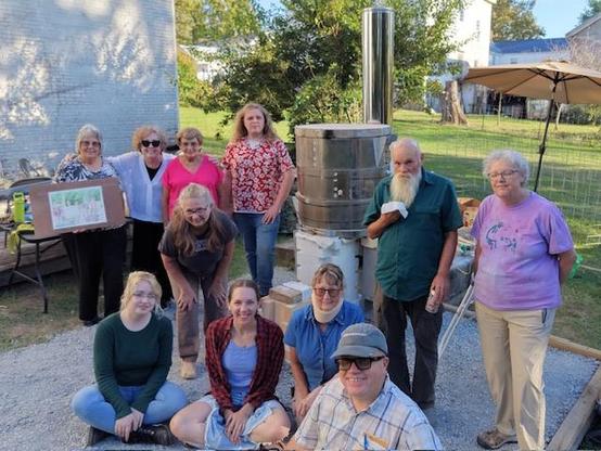 A bunch of happy potters after their first firing of the wood fired rocket kiln.
