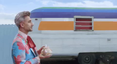 Fashionista Tan France walking by, winking and looking sassily into the camera, drinking tea straight from the teapot in the music video to Taylor Swift’s “You need to calm down”