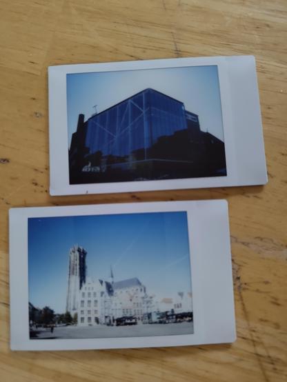 Two small polaroids, one with the conference venue, the other with the st rombauts tower