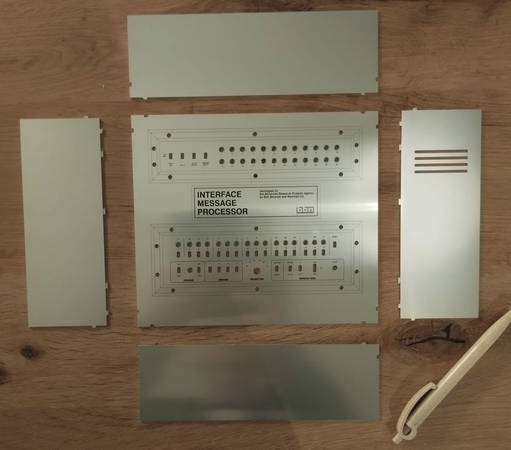 Metal parts for making a box with a front panel for the Interface Message Processor used in the ARPANET.