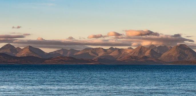 Distant mountains across a blue sea.