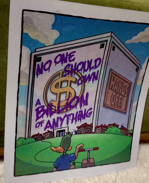 Lenticular left-right 3d effect print of the two “no one should own a billion of anything” cartoon frames.