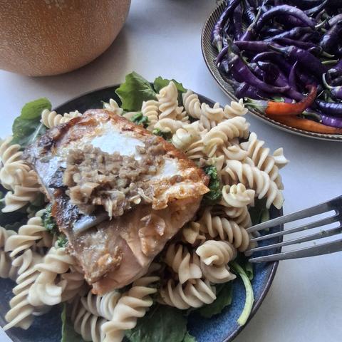 Salmon with fermented pepper on pasta with nettle pesto, on arugula. Plate of purple buena mulata peppers. Pie pumpkin.