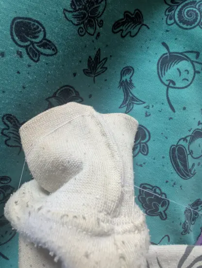 Fixing a hole in a white t-shirt with white thread, it's hard to see