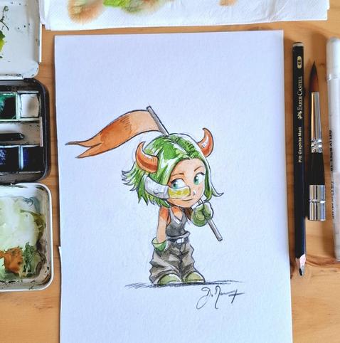 Photo of a watercolor on my desk: a little chibi character with green hair, an orange flag, and horns, orange skin and green eyes. Around the paper, pencils, brush and watercolor palette. (CC-By)