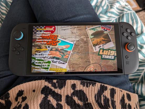 Photo of a Nintendo Switch 2 resting on my lap showing the credits screen in Mario Kart World.
