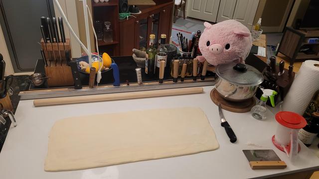A sheet of 81 layer croissant dough ready for cutting. No pictures of how it got from "a dough and a retangular sheet of butter" to this state, but imagine that 3 foot rolling pin doing a lot of work. Also my arms.