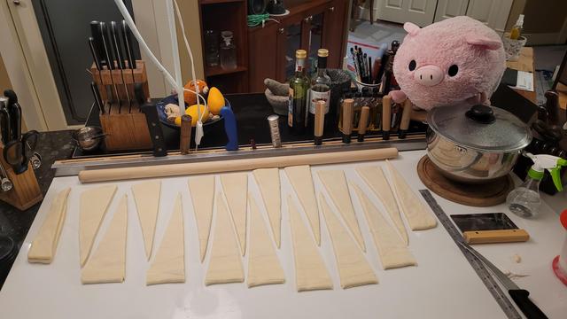 Eighteen cuts to get sixteen triangles (I'll let you work out why there's more cuts than triangles) that will get stretched and rolled.