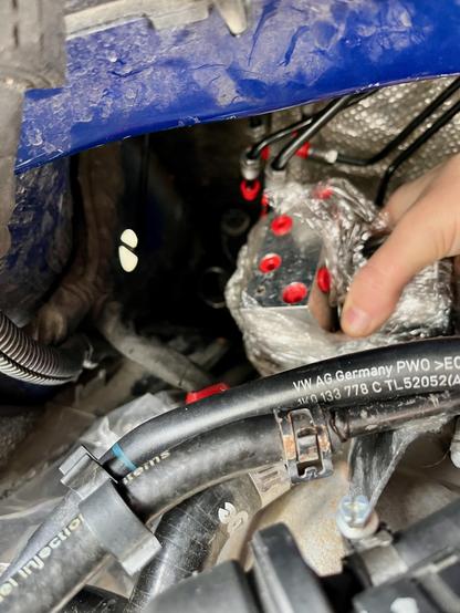 Finessing the ABS pump (still in plastic wrap) into its place in the engine bay. The hydraulic lines, capped off with red rubber plugs, are cumbersome, along with the coolant lines I have to contend with.
