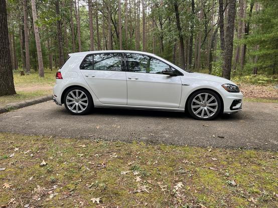 A white Mk7.5 Golf R with 18" R32 wheels, parked in a lovely wooded campsite. This combination makes my Golf R look way more bland than it is.