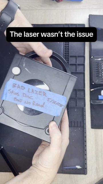 A repair technician troubleshoots a Nintendo GameCube that displays an error. The video shows the console being disassembled with iFixit tools, its circuit board removed, and close-up microsoldering work on the board.