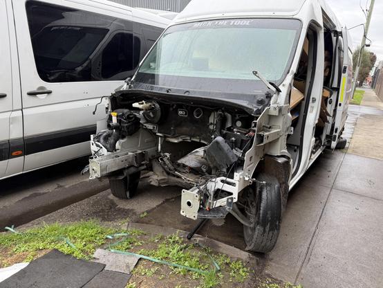 A van. Everything forward of the windscreen, including the engine, is missing. Letters above the windscreen read “MICK THE TOOL”.