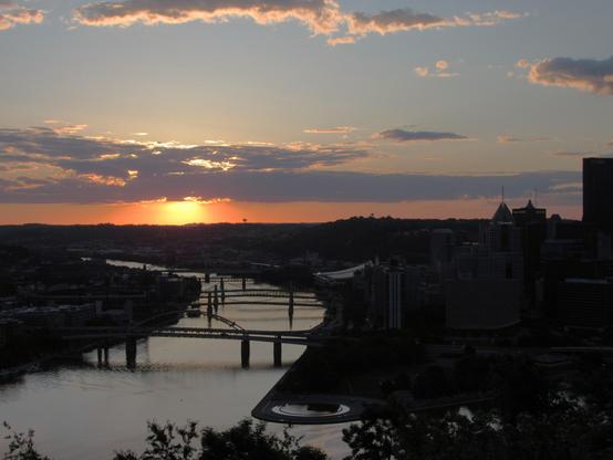 Taken from the neighborhood known as Mt Washington is the city of Pittsburgh, Pennsylvania, where Alice and I along with sweet little Bridget the cat will become residents. The confluence of the rivers - the Ohio, Allegheny, and Monongahela come together at a point, which is the tip of the "Golden Triangle". Some of the many bridges that span the rivers are visible connecting the triangle to the North shore. It is dawn, with a few long clouds spanning the frame. Dawn in the city, dawn of a new time in our lives.