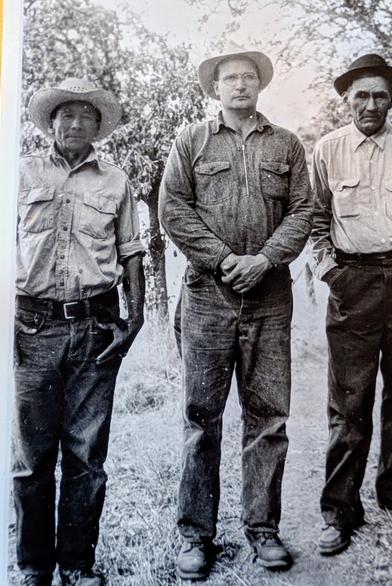 One taller white dude in glasses with two Wailaki men. They were on the Round Valley Reservation in Northern California.