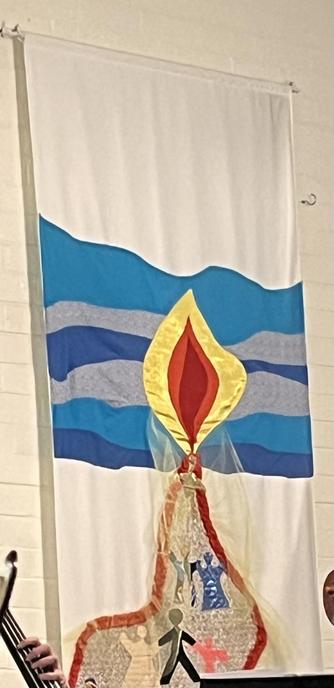A banner in a church hall, which is evidently intended to represent a candle flame against a blue background, with a path leading up to the flame and humanoid figures on that path. It was probably a Sunday school art project for a bunch of young children. But the shape and layering of the sides of the flame in the middle is… extremely vulvular. Possible interpretations of the path leading to the flabia are left as an exercise for the reader.