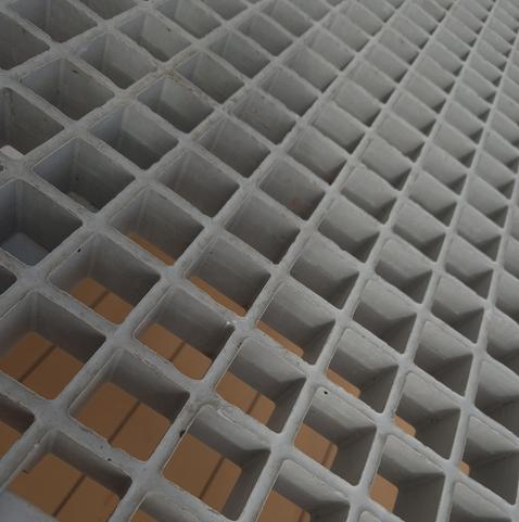 Close-up of grey expanded metal. The photograph was taken from the bottom left-hand corner, so that it looks as though the metal meets at the top right-hand corner.