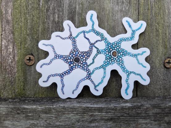 Sticker made from one of my original hand drawn pieces. The pattern looks a bit like two nerve cells that are highly connected. The background is a weathered wood fence.