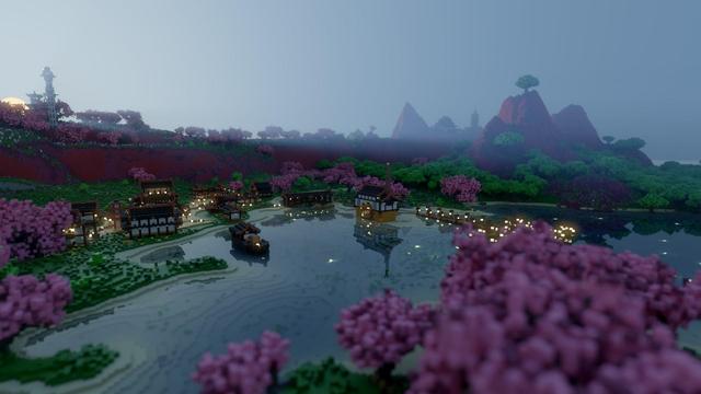 Render of Minecraft map Drehmal v2.1 PRIMORDIAL looking south over the bay in the Sahd region. The sun is just appearing over the hills which surround the bay on the far left, light grazing the slopes and illuminating the morning fog. The bay is clear, and the lights of the village on the far side are still on. Out of focus cherry blossoms sit in the foreground of the image on the near side of the bay.