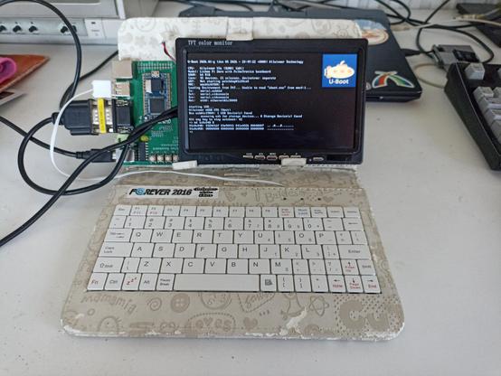 "Laptop" made of my custom baseboard with a lichee pi zero. The baseboard is at the left of the display, with connectors (vga and usb) on its left side. The case is a cheap tablet sleeâe including an usb keyboard, it's made mainly of cardboard covered with a thin layer of textured fake leather (that's falling apart, because this is getting a little old by now)

It's showing u-boot console on the vga display, complete with the u-boot logo