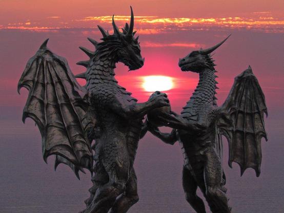 The Dragons In Love statue, with two dragons gazing at each other lovingly and holding an egg between them. This one has a sunset background.