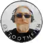 bearded man on one side of coin

dog on other.