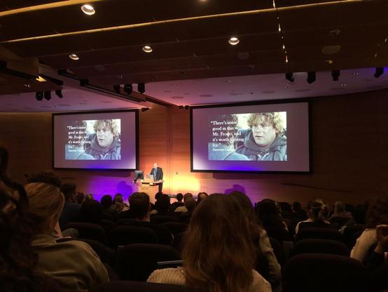 Michael Mann in front of a slide with a picture of Sam Gamgee from the Lord of the Rings saying "There's some good in the world, Mr Frodo and it's worth fighting for. "