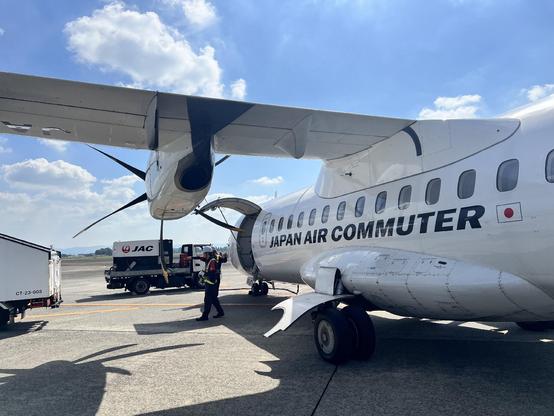 A small plane, labelled “Japan Air Commuter” sits on the tarmac.
