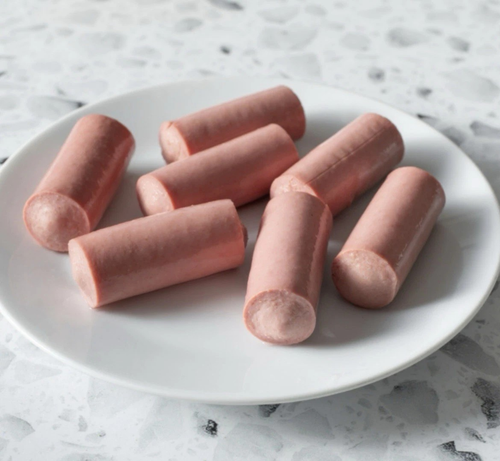an unappetizing plate full of cheap vienna sausages from a can