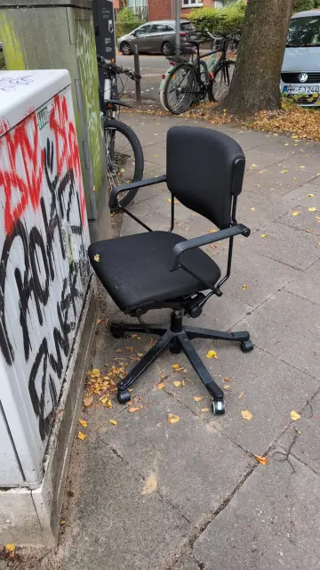 A random office chair on the street, it looks old but also high quality