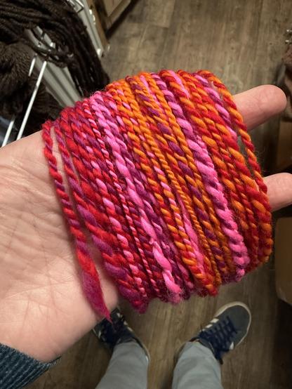 Some yarn that’s made up of random bits of pink, orange, pink, purple