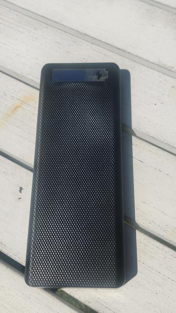 The assembled battery pack, just a long black rectangle with a picture of a battery on it.