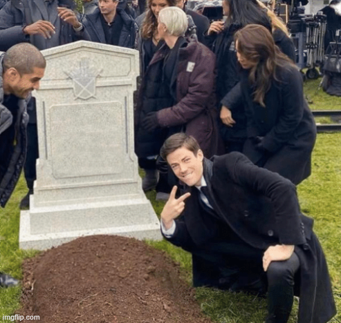 Image of the "Grant Gustin over a grave" meme (a young man kneeling over a grave with a cruel smile on his face and doing the victory sign with his fingers, while everyone else is appropriately mourning). No caption added.
