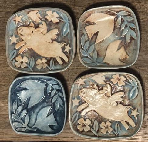 4 square plates. The design is a flying pig and doves with olive branch