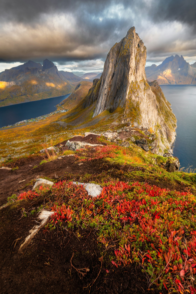 Segla, a iconic mountain peak on the island of Senja in Northern Norway.The western side of the peak plunges nearly vertically into the sea with a dramatic 600-meter drop, while the surrounding landscape features fjords, jagged mountain ridges, and sub-arctic tundra vegetation. #norway #geography #mountains #travel #nature